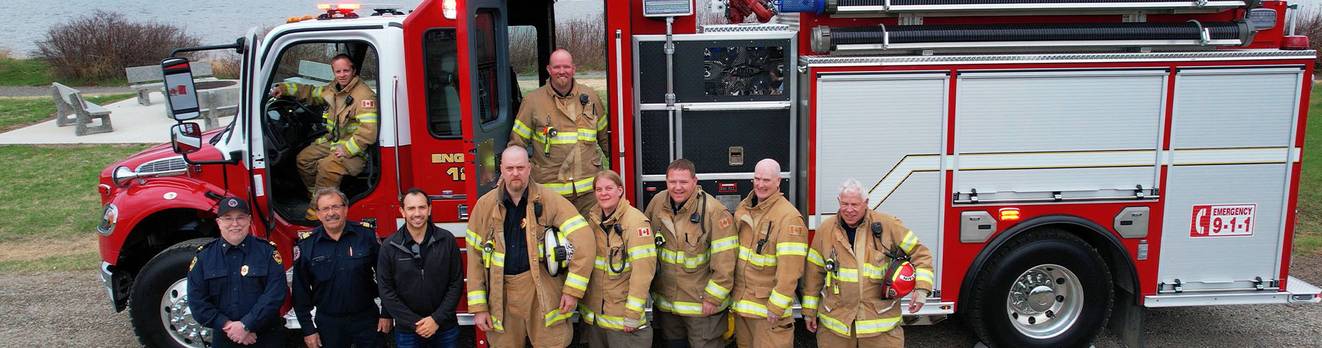 CGL with Fraser Lake Fire Department in front of the donated fire truck